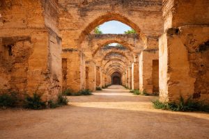 Interior of the Royal Granaries (Heri es-Souani) in Meknes, Morocco, featuring massive stone pillars, vaulted arches, and the historic grain storage halls built by Sultan Moulay Ismail.