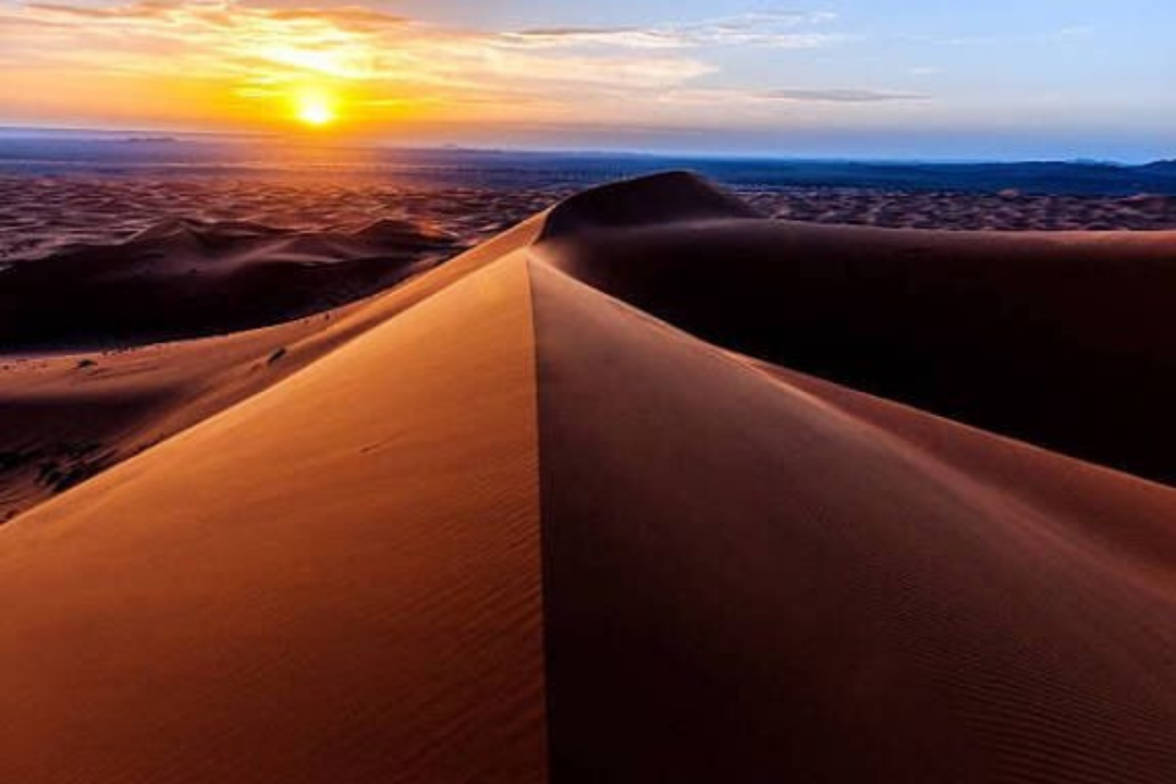 Beautiful sunrise lighting the orange dunes of Merzouga