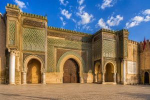 Bab Mansour Gate in Meknes, Morocco, featuring magnificent zellige mosaics, carved stone architecture, and the iconic entrance to the Imperial City.