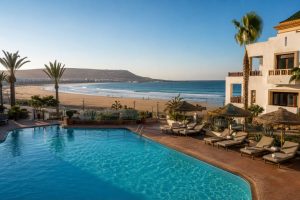 Swimming pool at a beachfront hotel overlooking Agadir beach and the Atlantic Ocean