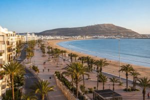 Panoramic view of Agadir Corniche, its palm-lined promenade, sandy beach and Atlantic Ocean