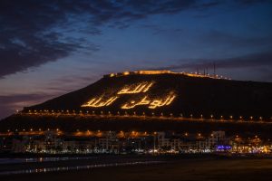 Agadir Oufella hill illuminated at night with the Arabic motto Allah, Al Watan, Al Malik